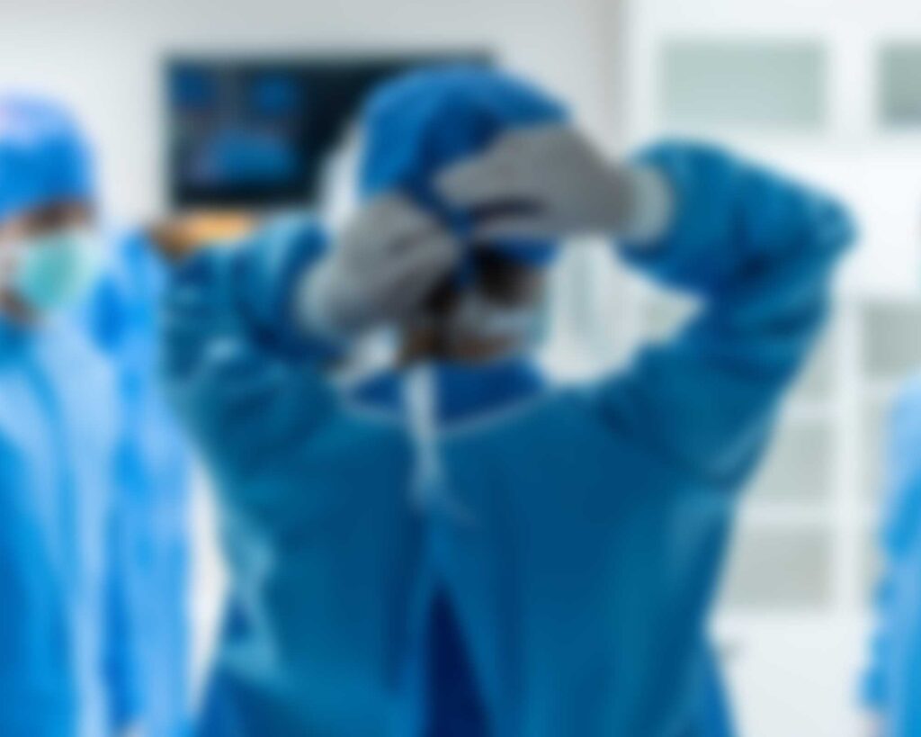 Symmetry nurse tying mask walking into surgery